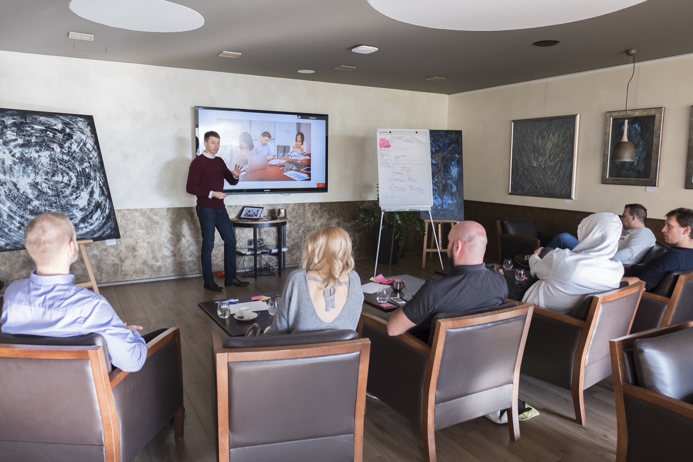 Michal Juhas presenting to workshop participants in a lounge setting (2018)
